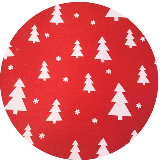 Red circular fabric with white Christmas tree and snowflake pattern