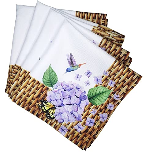 Set of four napkins with floral and butterfly design on woven placemats.
