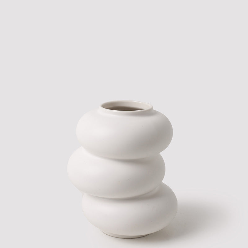 White ceramic vase with stacked design on a light gray background